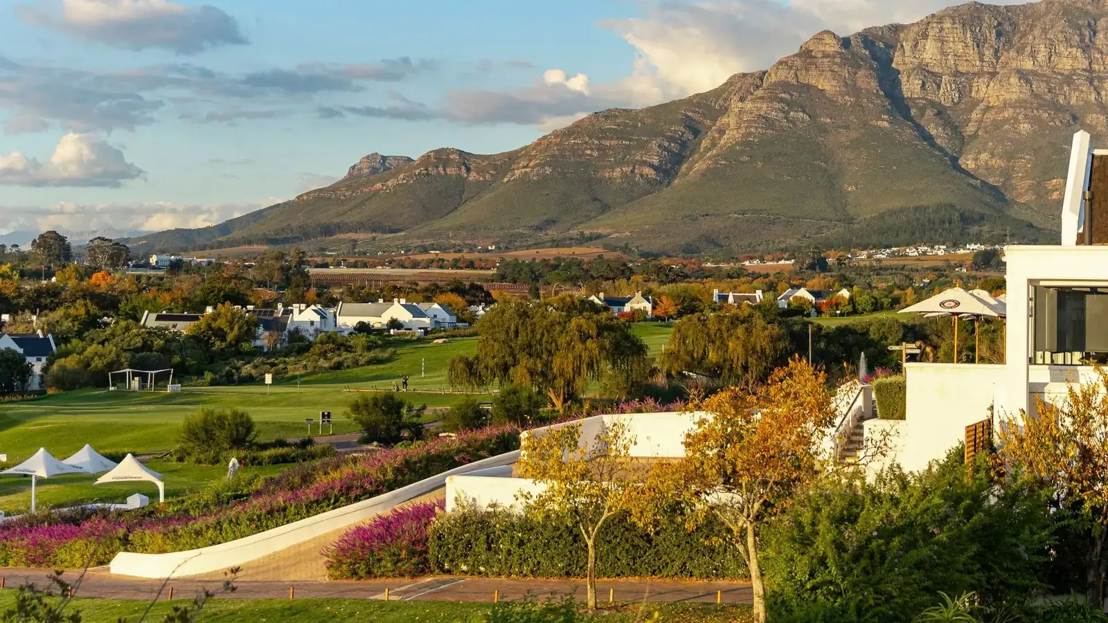 Elevated view across De Zalze Winelands Golf Estate fairways and Cape Dutch lodges with the Helderberg mountains in the background, Stellenbosch