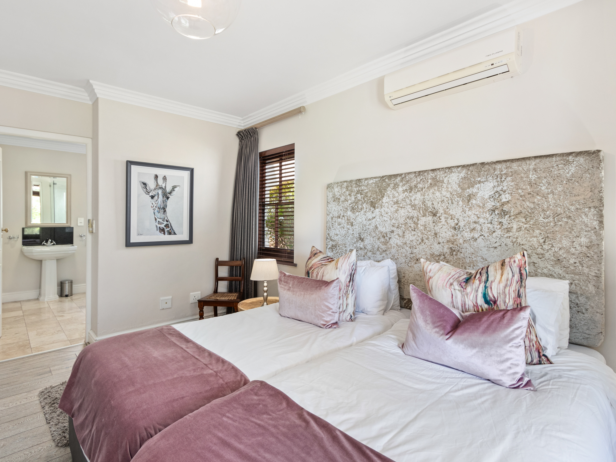 Master bedroom with velvet headboard and en-suite