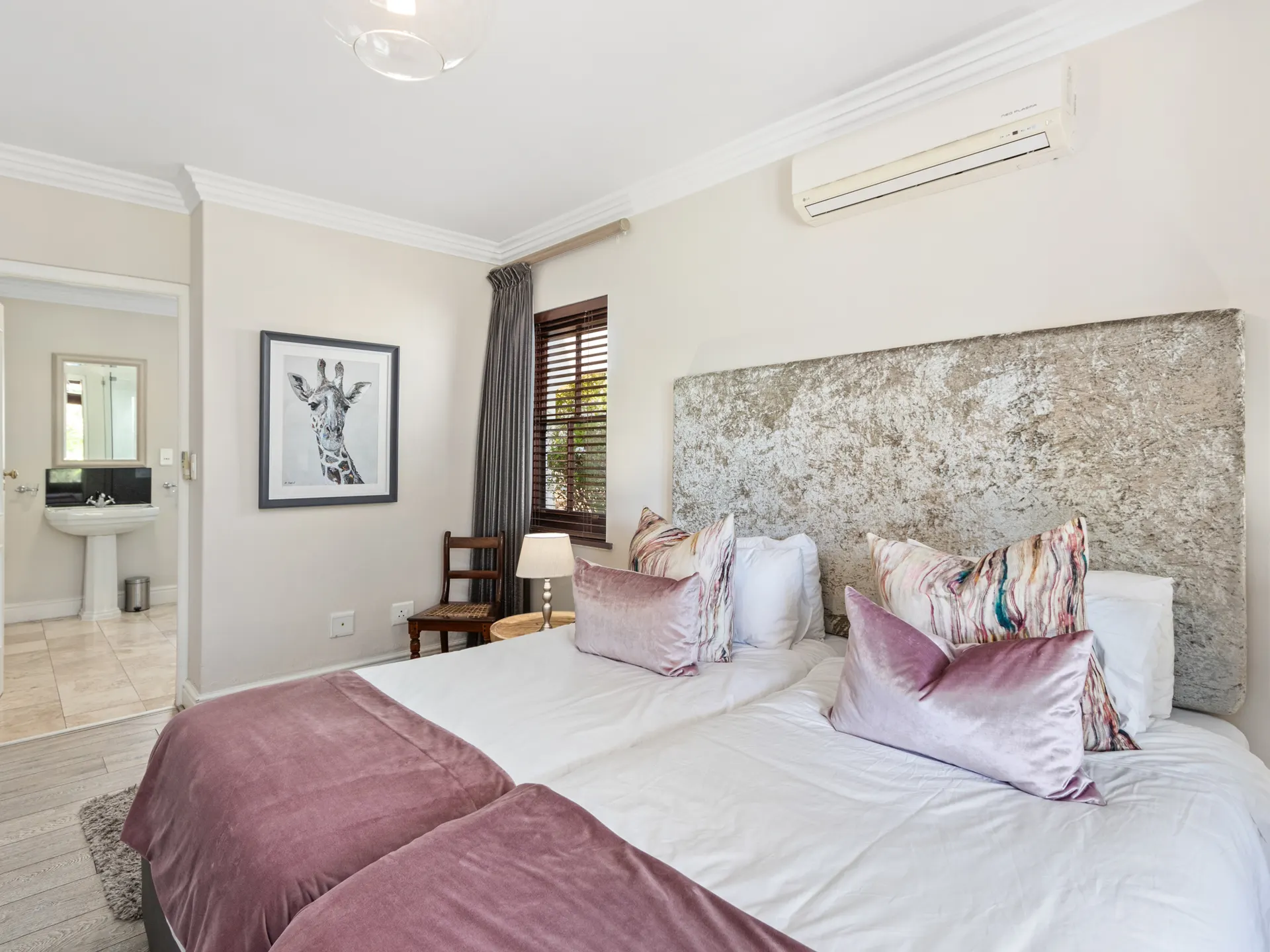Master bedroom with velvet headboard and en-suite