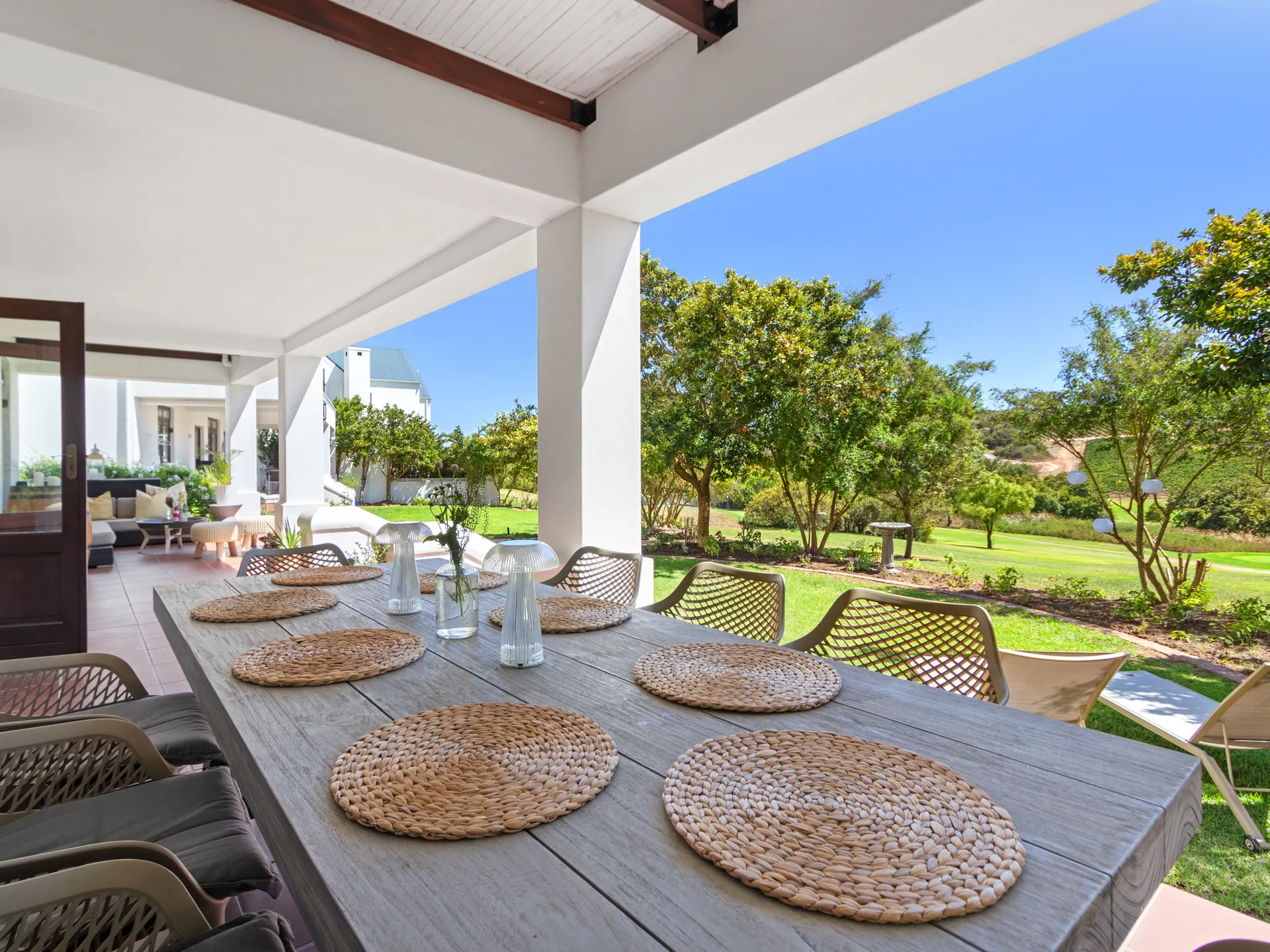 Covered patio dining table overlooking garden and golf course