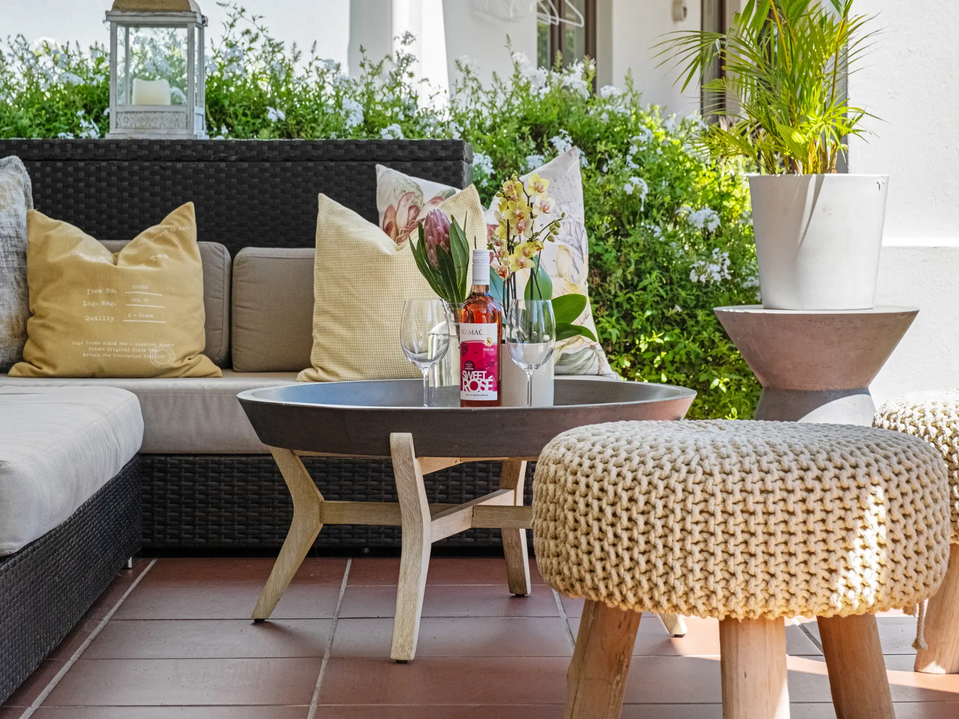 Veranda lounge with rosé wine and garden view